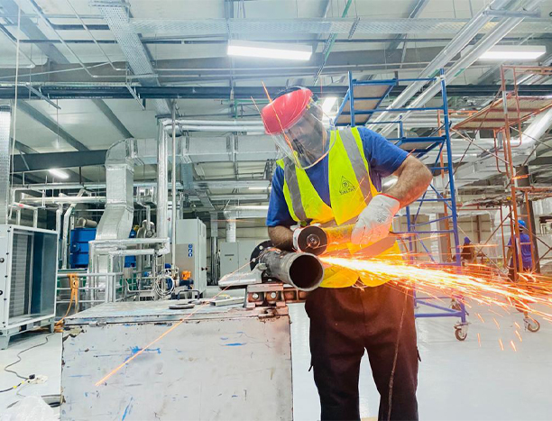 worker cutting metallic pipe