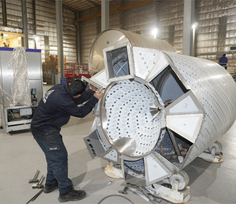 worker engaged in construction of large industrial equipment