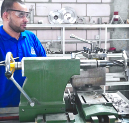 worker shaping metal using industrial tools