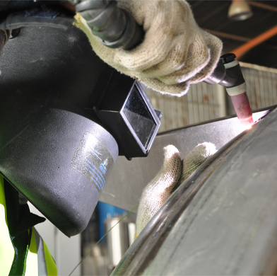 worker wearing face protection welding
